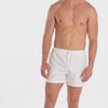 A WHITE WALL VIDEO OF A MALE MODEL WEARING THE AMMY SHOP UNISEX EVERYDAY SWEAT SHORT IN SNOW